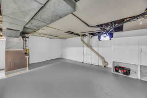 Basement featuring heating unit