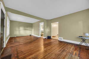 Unfurnished living room with dark hardwood / wood-style flooring