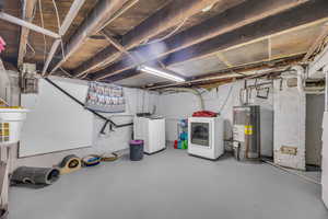 Basement featuring washer and dryer and water heater