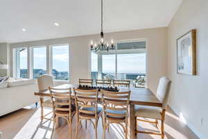 Dining room with a notable chandelier and light hardwood / wood-style flooring