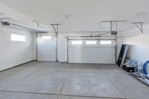 Garage featuring a garage door opener