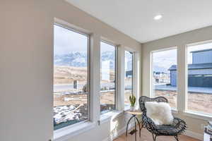 Sunroom / solarium featuring a wealth of natural light and a mountain view