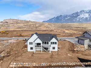 Rear view of house with a mountain view and a balcony