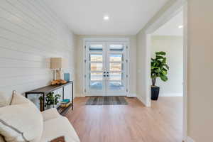 Entrance foyer featuring light wood-type flooring and french doors