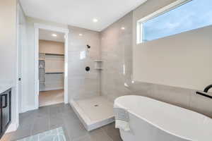 Bathroom featuring vanity, tile patterned floors, and independent shower and bath