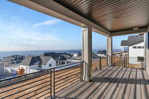 Wooden terrace with a water view and a playground