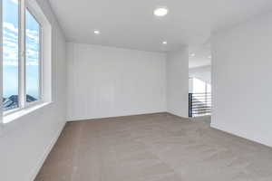 Empty room with light colored carpet