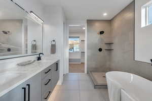 Bathroom featuring independent shower and bath, tile patterned flooring, and vanity