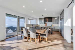 Dining space featuring a barn door, sink, and light hardwood / wood-style floors