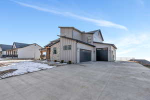 Snow covered property featuring a garage