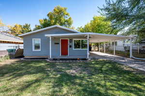 View of front of home with a front lawn and a carport