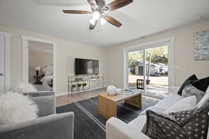 Living room featuring ceiling fan and light wood-type flooring