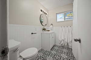 Bathroom featuring tile patterned flooring, vanity, and toilet