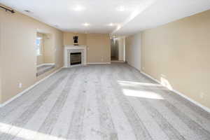 Large family room in the basement with new carpet