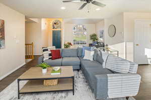 Living room with wood-type flooring and ceiling fan