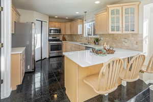 Kitchen with appliances, and a breakfast bar area