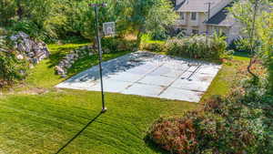 View of sport court featuring a yard