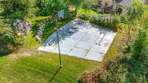 View of basketball court with a lawn