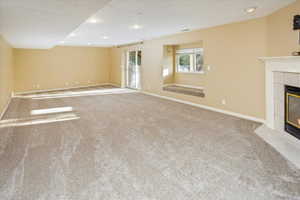 Large family room in the basement with new carpet