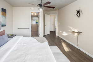 Master Bedroom with ceiling fan and dark hardwood / wood-style floors