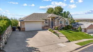 View of front facade with a front yard and a garage