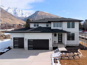 Prairie-style house with a mountain view and a garage