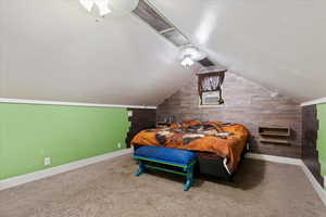 Bedroom featuring carpet flooring, ceiling fan, vaulted ceiling, wooden walls, and cooling unit