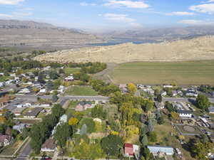 Drone / aerial view featuring a water and mountain view