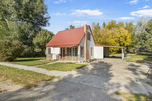 View of front of home with a front lawn and a carport