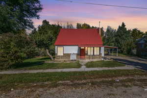 View of front of house featuring a yard and a carport