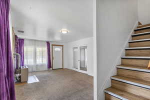 View of carpeted entrance foyer