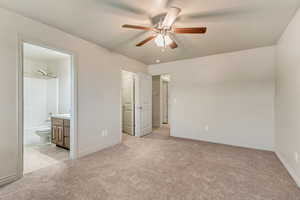 Primary bedroom featuring ensuite bathroom and walk in closet