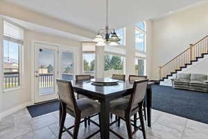 Dining area featuring light colored carpet and a chandelier