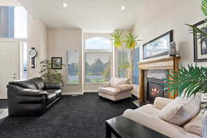 Carpeted living room featuring a towering ceiling