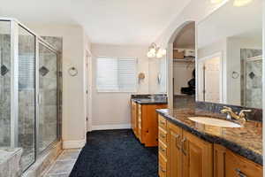 Bathroom featuring vanity and a shower with shower door