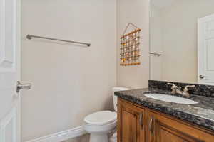 Bathroom with tile patterned flooring, vanity, and toilet