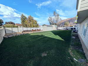 View of yard with a storage unit and a mountain view