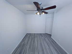 Spare room featuring ceiling fan and dark hardwood / wood-style flooring