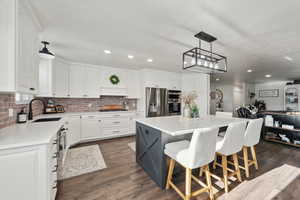 Kitchen a center island, and white cabinetry