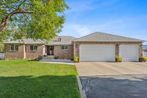 Single story home with a private front yard and a garage