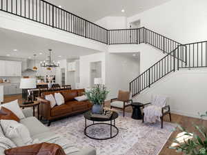 Family room featuring, light hardwood / wood-style floors, and a high ceiling