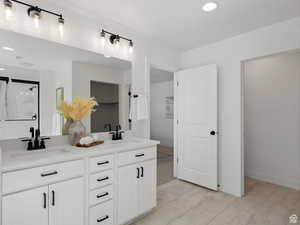 Bathroom with tile patterned floors and vanity