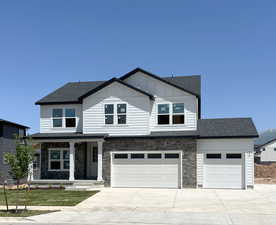 View of front of house with a porch and a garage