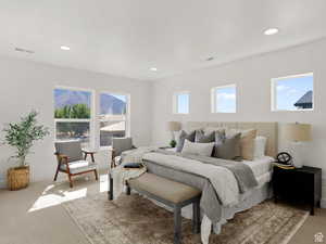 Bedroom featuring light colored carpet