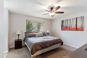 Carpeted bedroom with ceiling fan