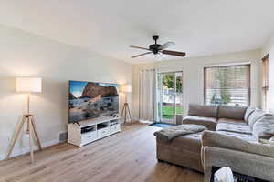 Living room featuring ceiling fan and light hardwood / wood-style floors