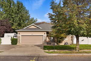 View of front of home with a garage and a front lawn