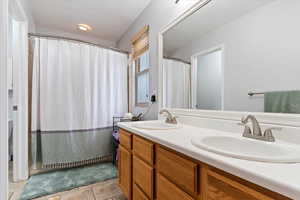 Bathroom with tile patterned flooring and vanity