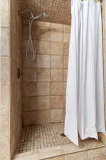 Bathroom featuring a shower with shower curtain