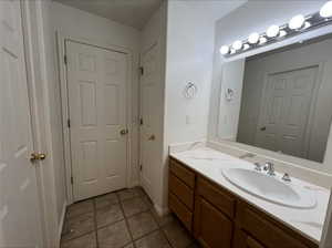 Bathroom featuring vanity and tile patterned flooring